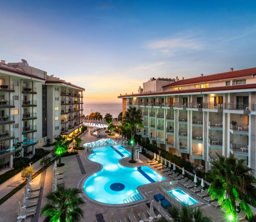 an aerial view of a resort with a swimming pool at Ramada Hotel & Suites by Wyndham Kusadasi in Kuşadası