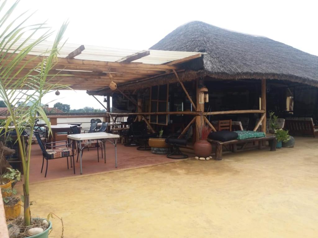 a large hut with a table and chairs in it at Tourist Home in Mbale