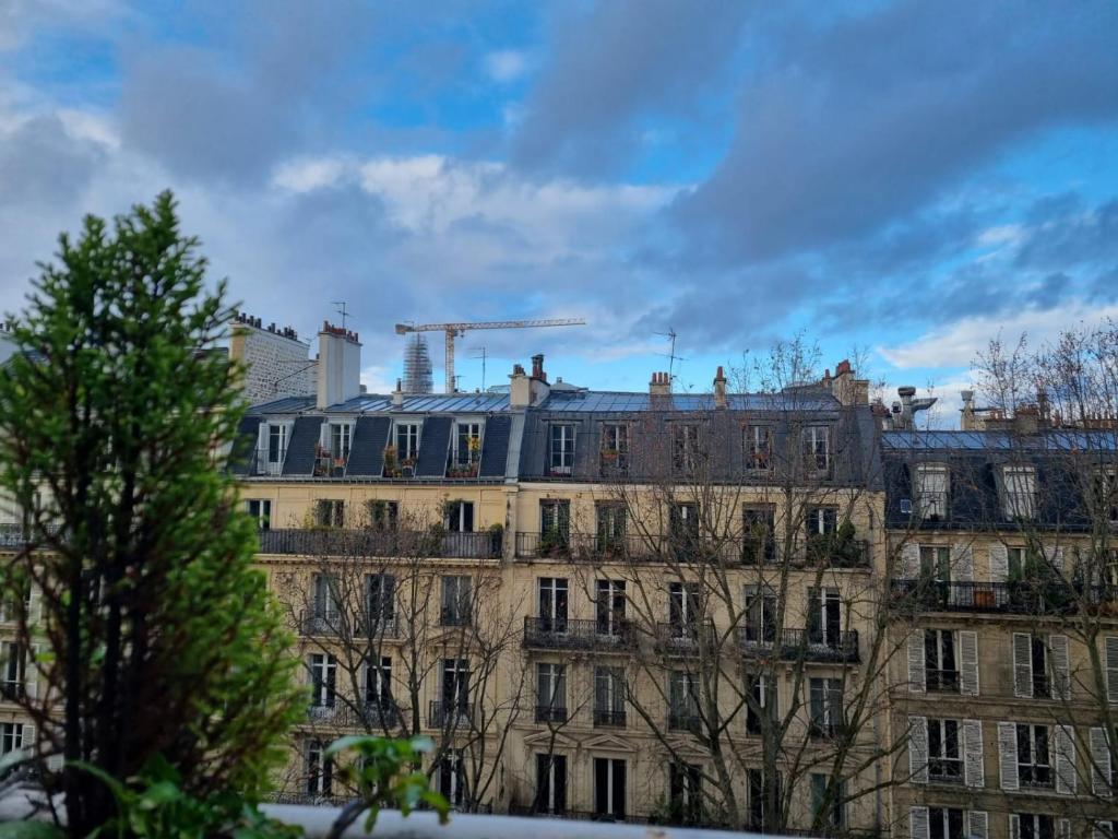 a large building with a crane on top of it at Appartement cosy Notre-Dame in Paris