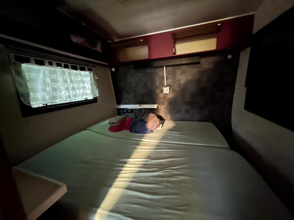 a small child laying on a bed in a room at Drügen Kamp in Haltern