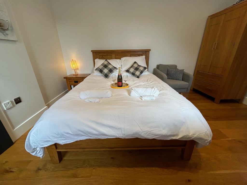 a bedroom with a large white bed with two towels at NEW King Bed Romantic Cabin - Must See Landscapes in Salisbury