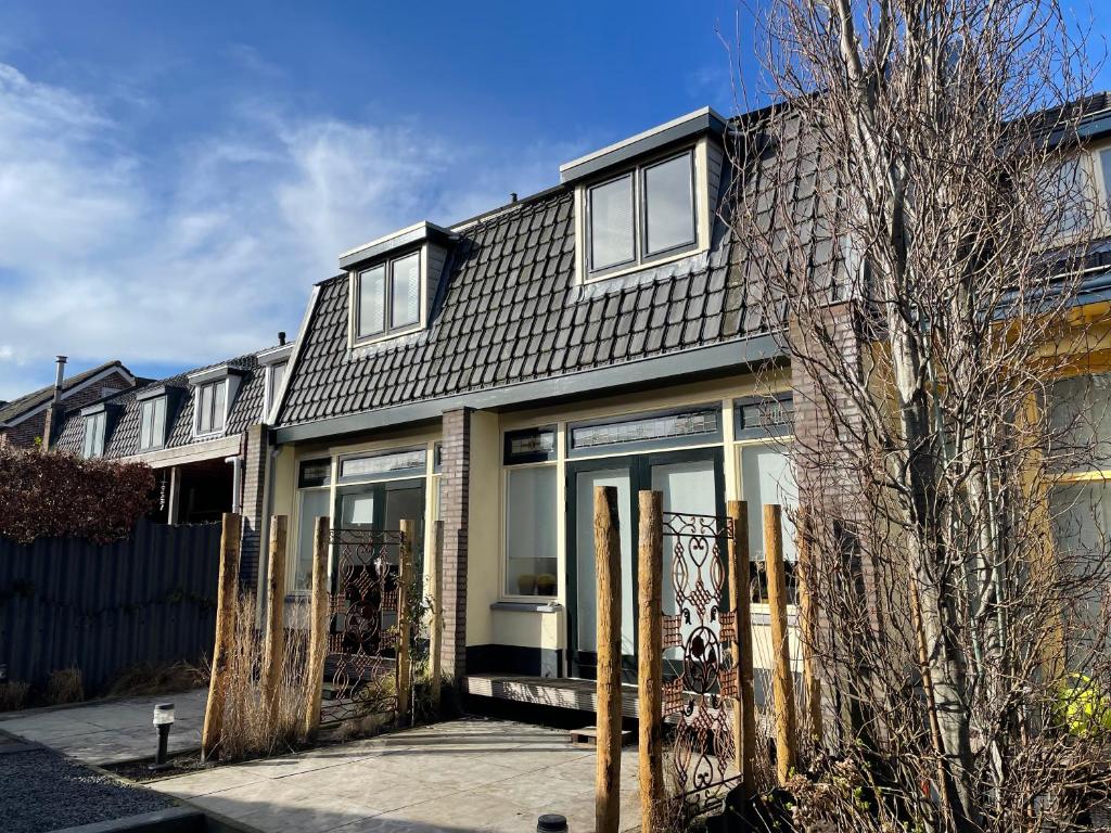 a house with sliding glass doors on it at Holiday in Spakenburg Ootje in Spakenburg