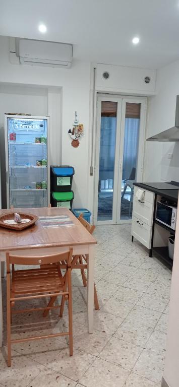 a kitchen with a wooden table in a room at CasaRA in Bari