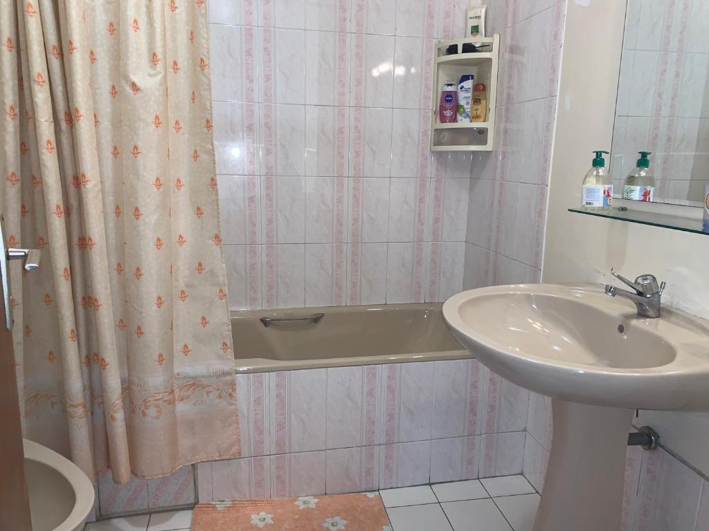 a bathroom with a sink and a tub and a shower at Elegant and Panoramic 3-Bedroom in Central Tangier in Tangier