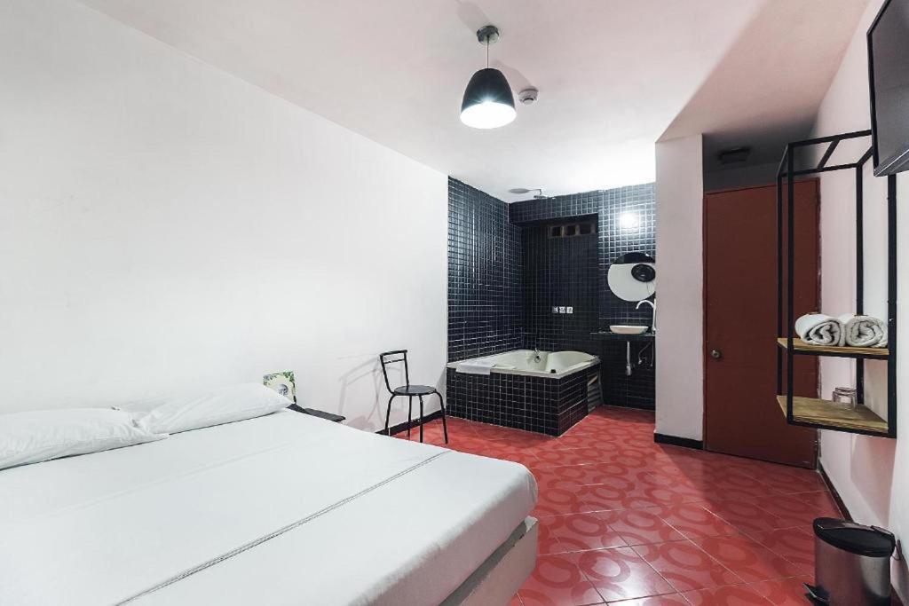 Postel nebo postele na pokoji v ubytování Green Hotel Natural Medellin