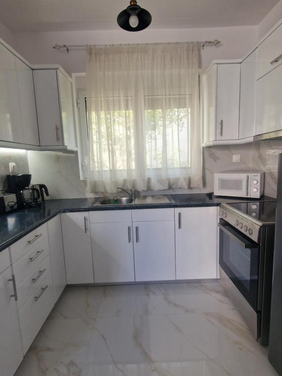 A kitchen or kitchenette at Maria's Apartments