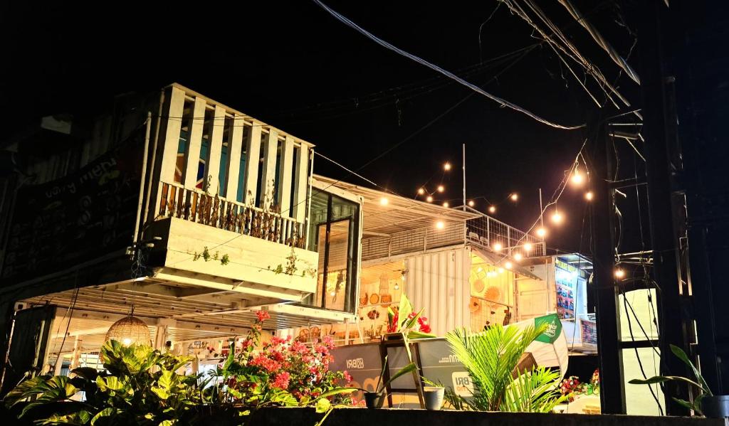a building with a balcony on the side of it at night at Karcof Container Hostel in Senggigi 