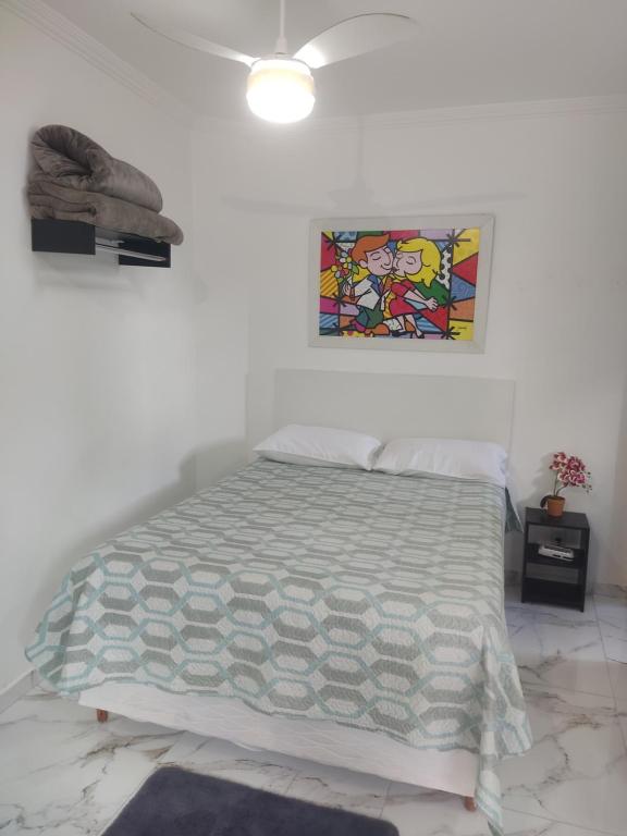 um quarto com uma cama e um quadro na parede em Casa Nova Centro de Penedo em Penedo