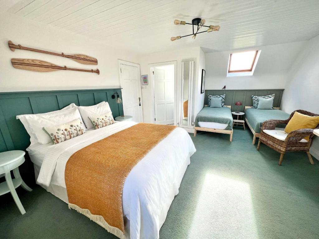 a bedroom with a bed and a couch and a chair at Thistledown Lodge in Fethard on Sea