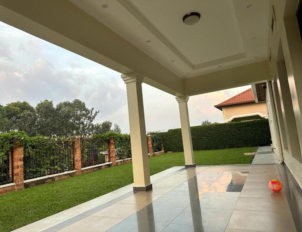 a porch with a view of a yard at Cento Stalloni in Kigali