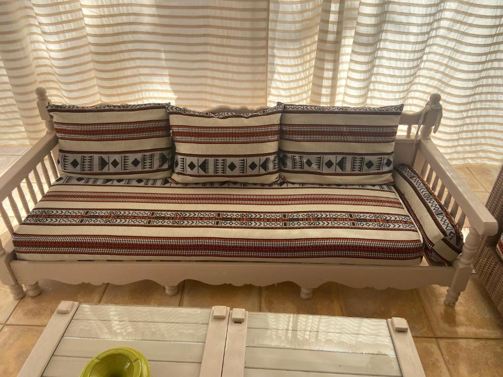 a couch sitting in front of a window at RESIDENCE DAR YASMINa in Mezraya