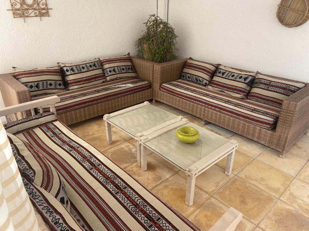 a living room with two couches and a coffee table at RESIDENCE DAR YASMINa in Mezraya
