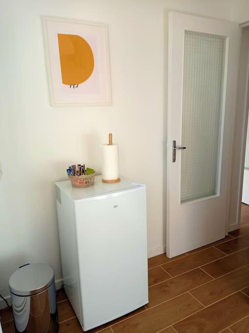 a white refrigerator with a candle on top of it at Appartement de charme à Digoin #2 in Digoin