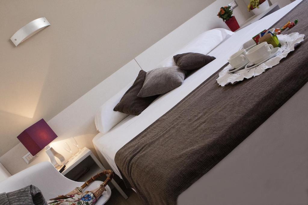 Postel nebo postele na pokoji v ubytování Hotel Mennini
