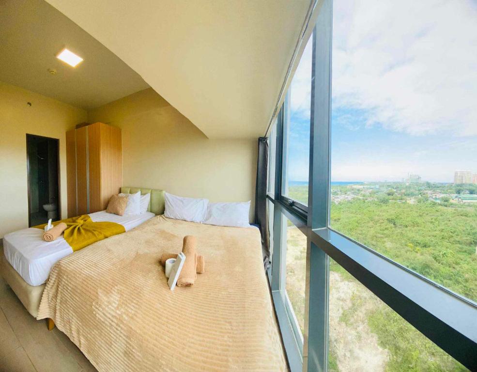 Ένα ή περισσότερα κρεβάτια σε δωμάτιο στο The Mactan Newtown