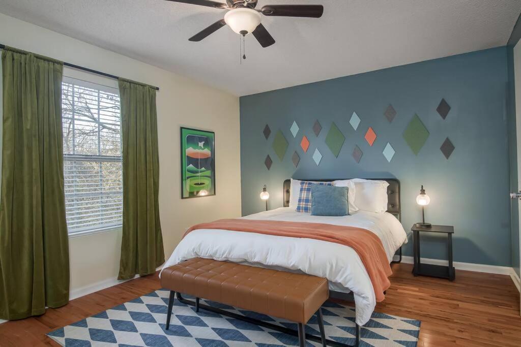 a bedroom with a bed and a ceiling fan at Golden Oasis: Luxurious 3-BR Home w/ Fun Galore! in Augusta