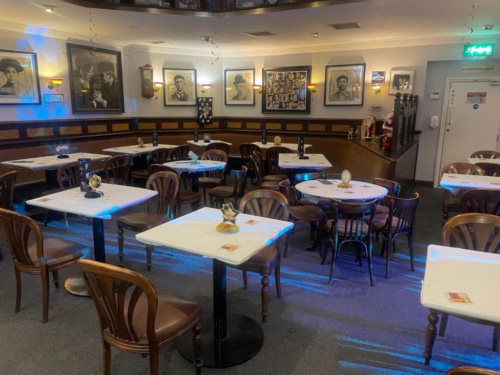 a dining room with tables and chairs in a restaurant at The Office Bar and Restaurant in Dudley