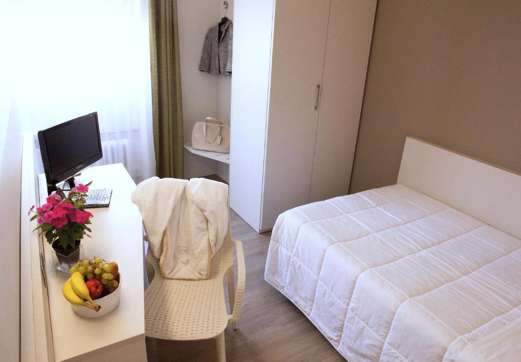 Postel nebo postele na pokoji v ubytování Hotel Mennini