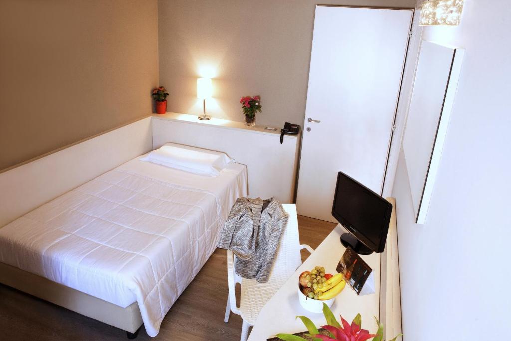 Postel nebo postele na pokoji v ubytování Hotel Mennini