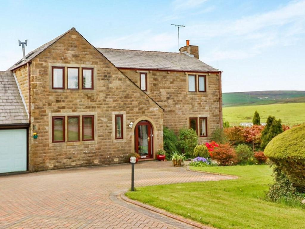 a large brick house with a driveway at Parkin House Guest House in Todmorden
