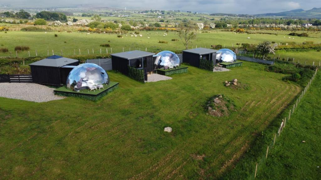 an aerial view of four domes in a field at Glamping Boutique Domes in Articlave