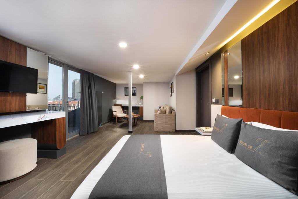 a hotel room with a bed and a living room at Second Suit Hotel in Istanbul