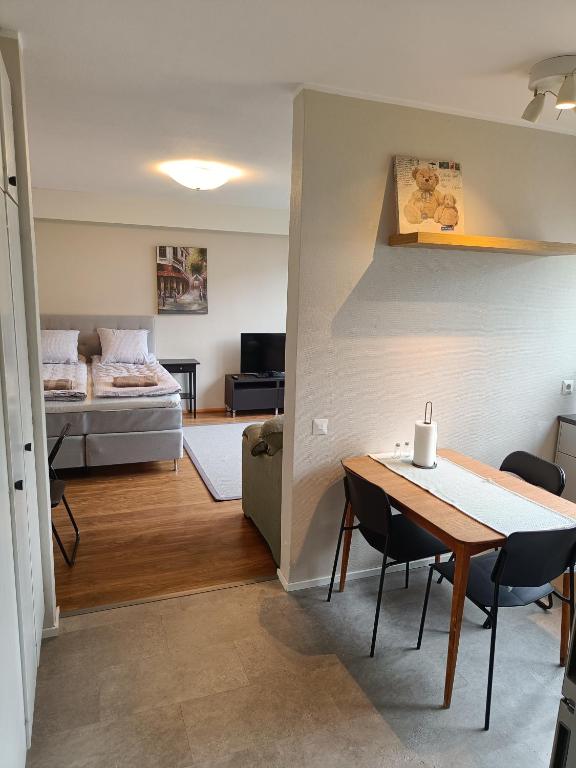 ein Wohnzimmer mit einem Tisch und einem Bett in der Unterkunft Lägenhet på markplan in Mariehamn
