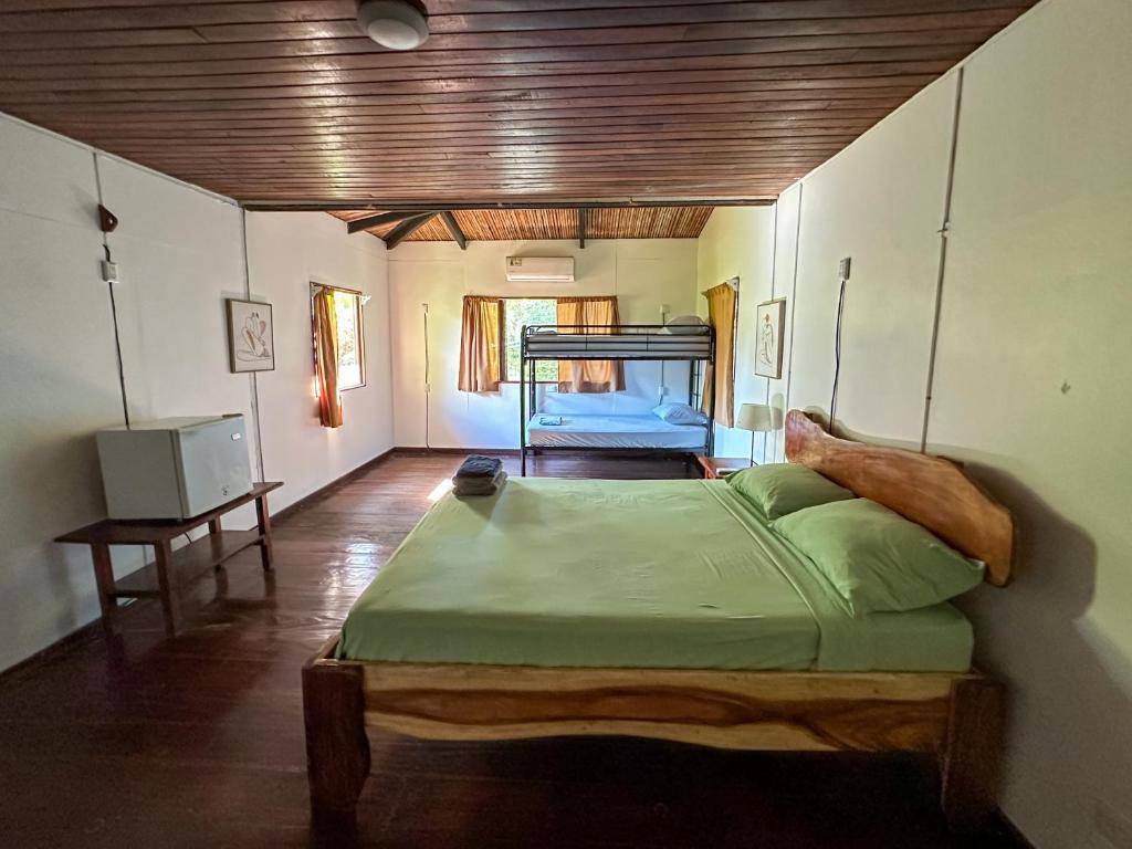 a bedroom with a large bed in a room at El Clan Hostel in Puerto Viejo