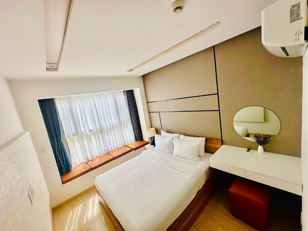 a small room with a bed and a window at Scenic Valley 2 in Ho Chi Minh City