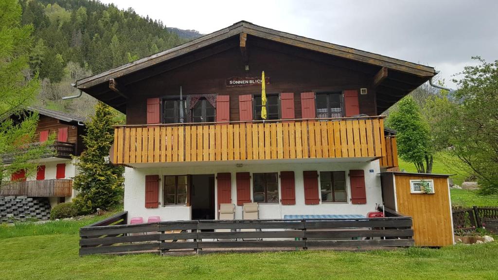 a large house with a balcony on top of it at Chalet Sonnenblick in Fiesch