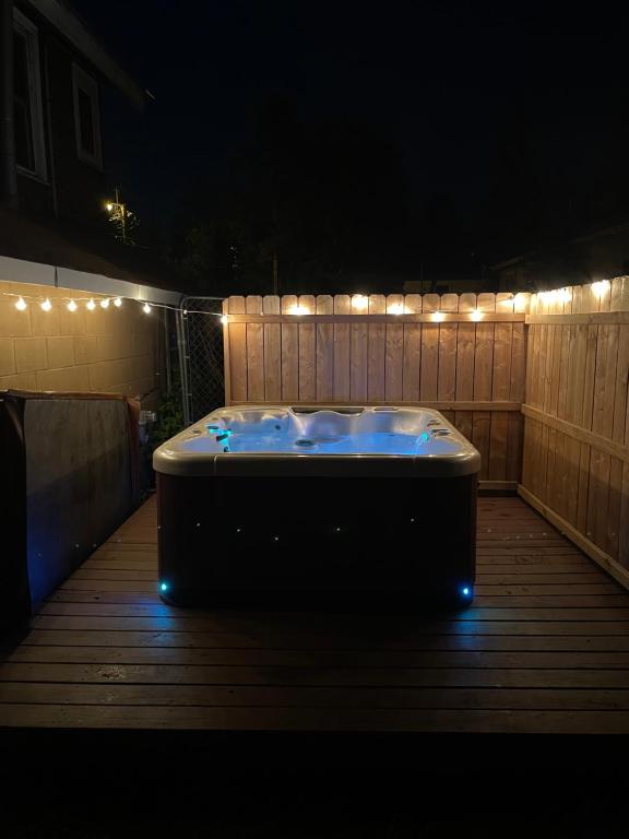a bath tub sitting on a deck at night at 1892 historical apartments in Mountain Iron