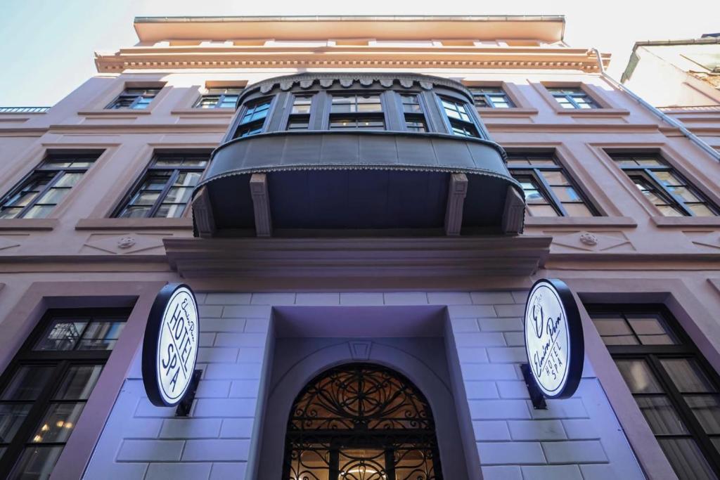 a building with two clocks on the front of it at Elmira Pera Hotel & - Special Class in Istanbul