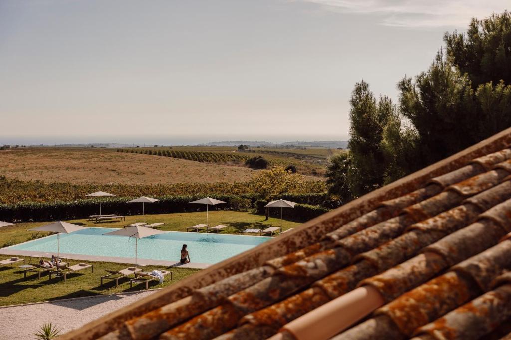 a view of a swimming pool from the roof of a house at Masseria del Carboj in Menfi