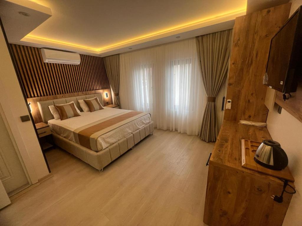 a hotel room with a bed and a television at Ninova Boutique Hotel in Istanbul
