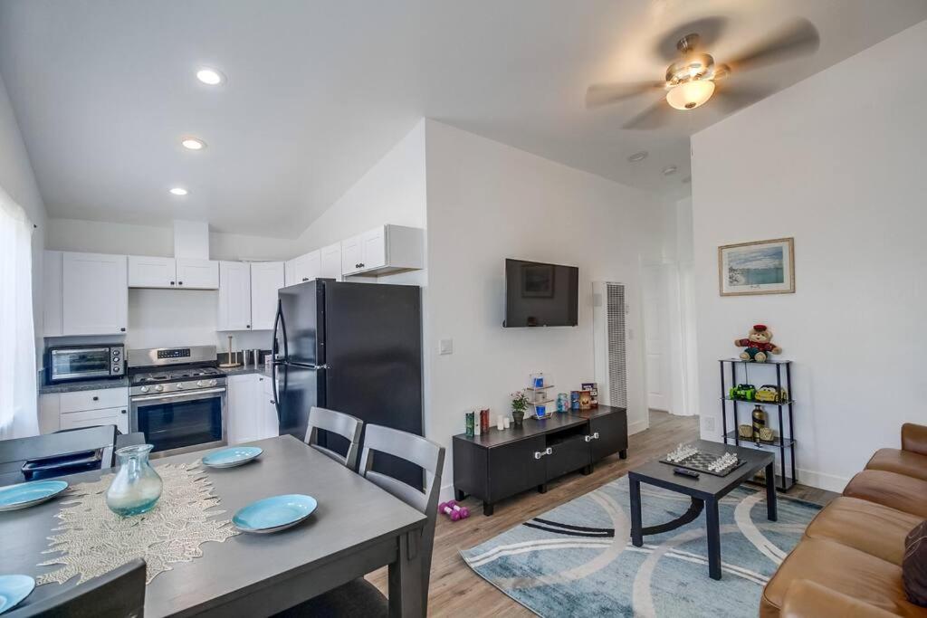 a living room with a table and a kitchen at Entire First-Floor 3-Bedroom w Gated Yard, Laundry, Crib, Fast Wi-Fi, Private Rental, No Deposit in San Diego