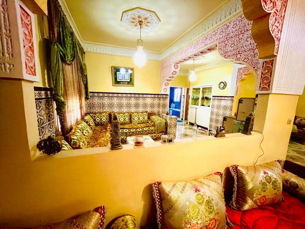 a living room with a couch and a mirror at Tanja tanger moroco in Tangier