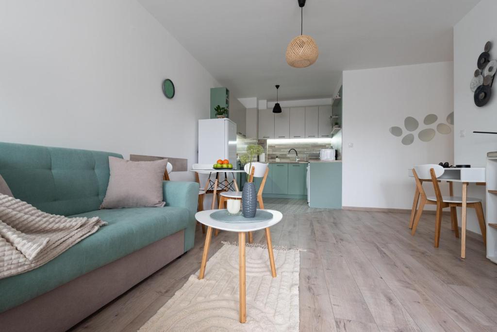 a living room with a green couch and a table at Apartment KALINA with free private parking in Plovdiv