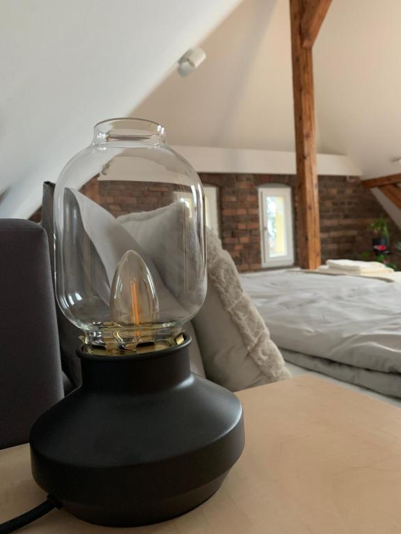 a glass trophy on a table in a bedroom at Apartamenty Astor - Księżycowy in Szczawno-Zdrój