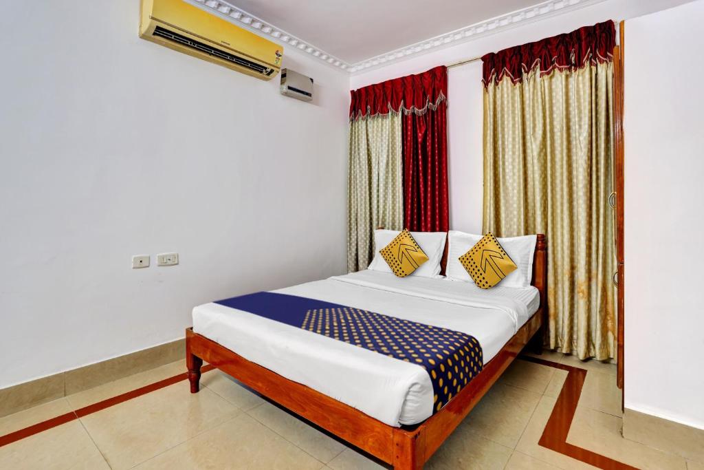 a bedroom with a bed and a window at OYO Majestic Inn in Trivandrum