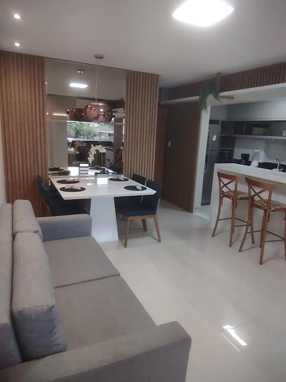a living room with a couch and a table with chairs at Morada Góes Calmon in Itabuna