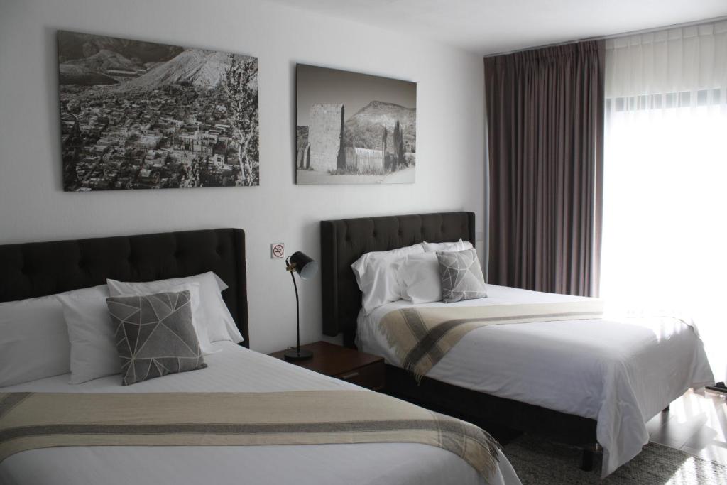 Postel nebo postele na pokoji v ubytování HOTEL MINA REAL