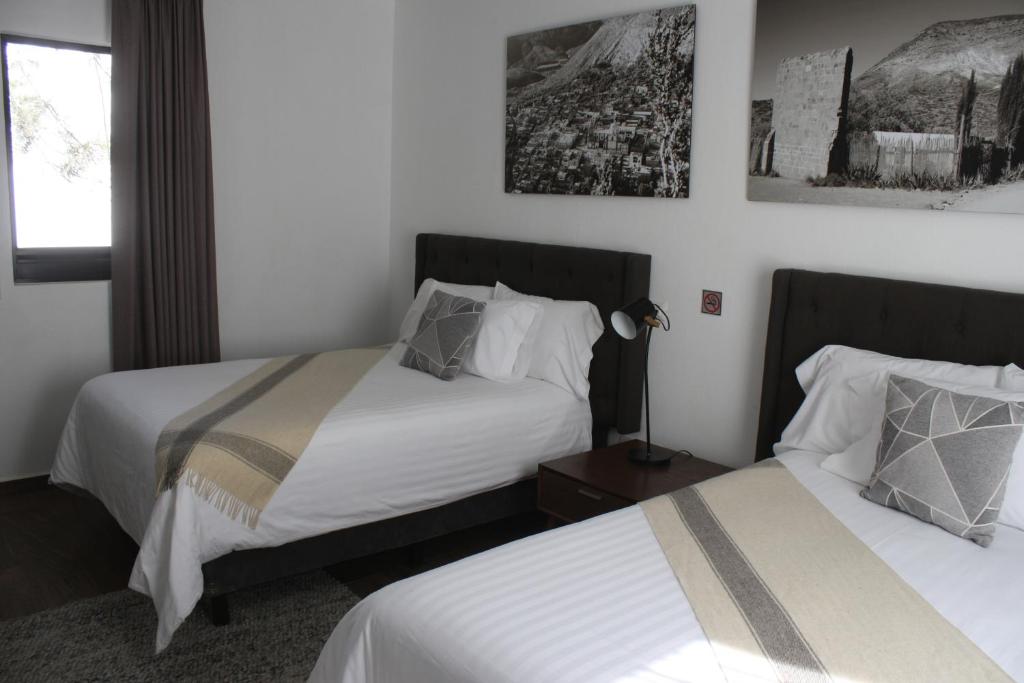 Postel nebo postele na pokoji v ubytování HOTEL MINA REAL