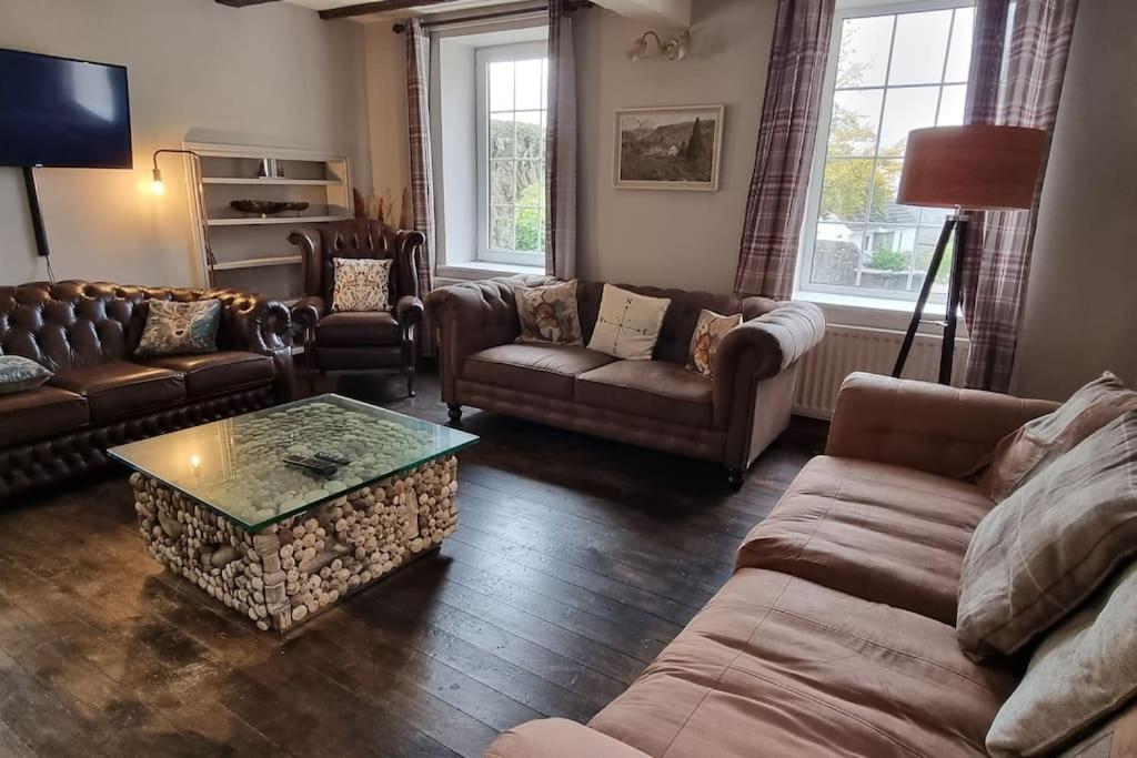 a living room with couches and a coffee table at Peaceful Countryside Retreat near Beach/Lakes in Distington