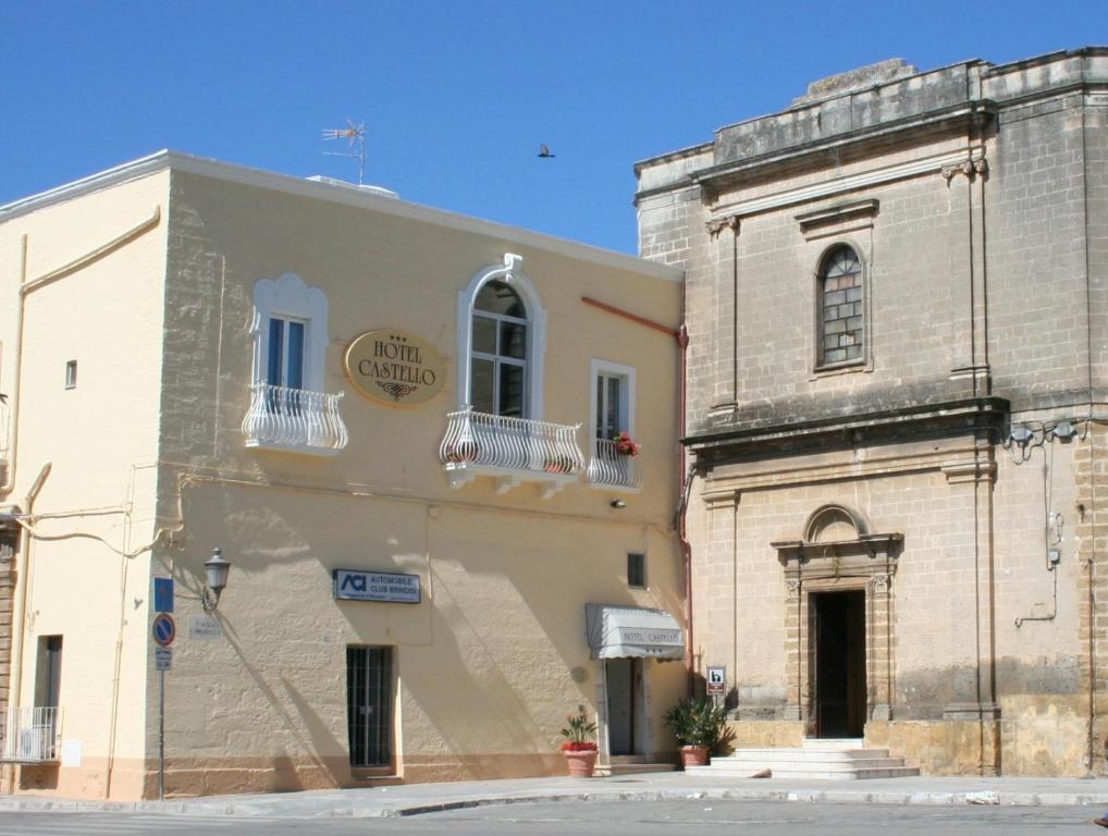 a building in front of a church at Hotel Castello in Mesagne