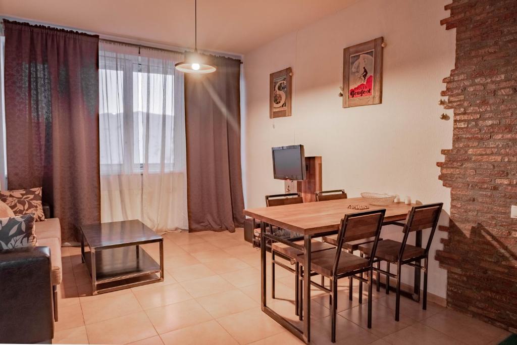 a living room with a wooden table and chairs at 2-room Apartment NFT Gudauri Penta 405 in Gudauri