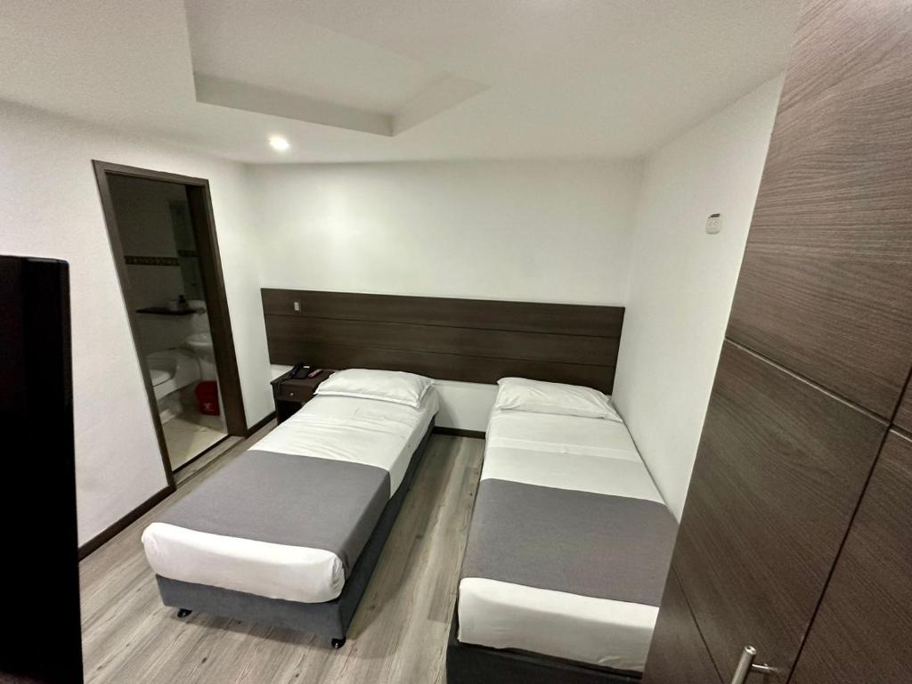 Postel nebo postele na pokoji v ubytování Hotel Expo Hotel Ferial