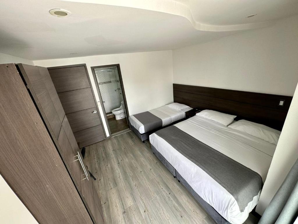 Postel nebo postele na pokoji v ubytování Hotel Expo Hotel Ferial