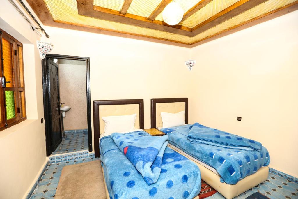 Postel nebo postele na pokoji v ubytování Kasbah Du Roches Armed