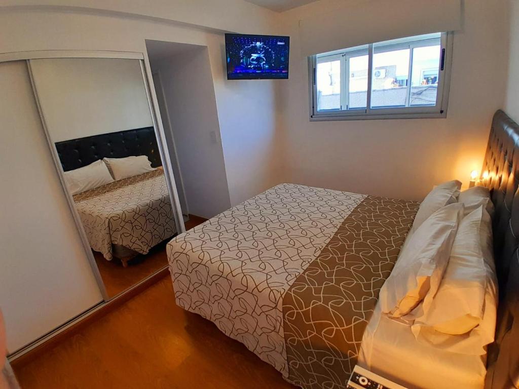 a bedroom with a bed and a large mirror at Edificio Recoleta in Buenos Aires