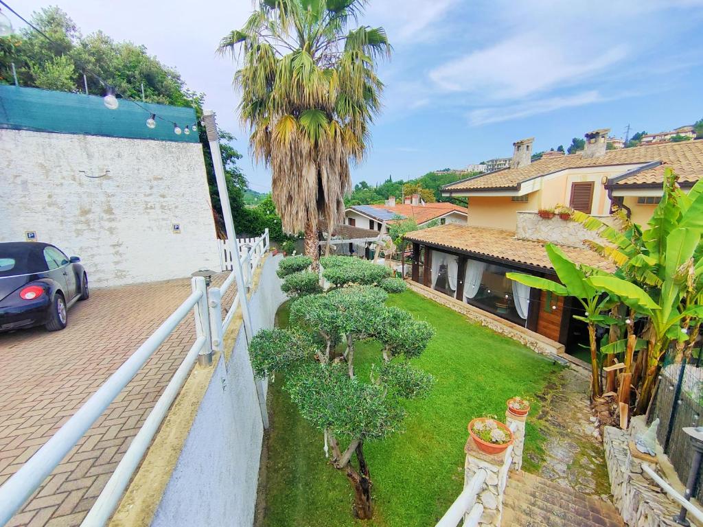 a car parked next to a house with a yard at Favola Exclusive b&b in Pescara